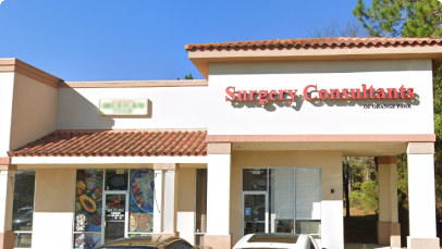 A modern single-story building in Hollywood housing a business named "surgery consultants" with ample parking in front and clear blue skies overhead.