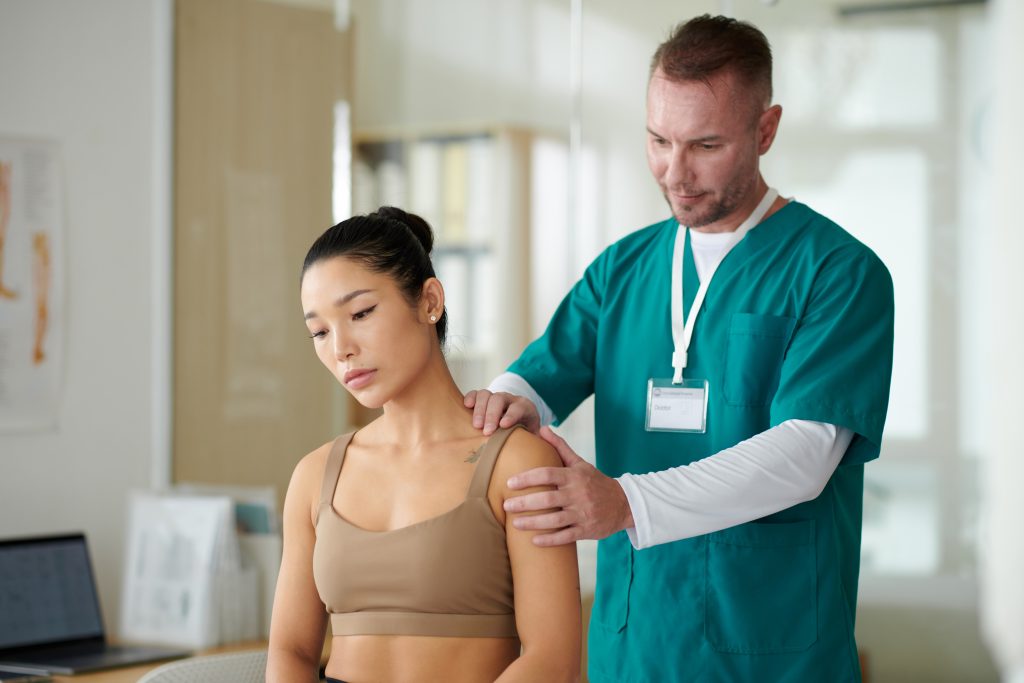 therapist working with a patient on pain management in the shoulder