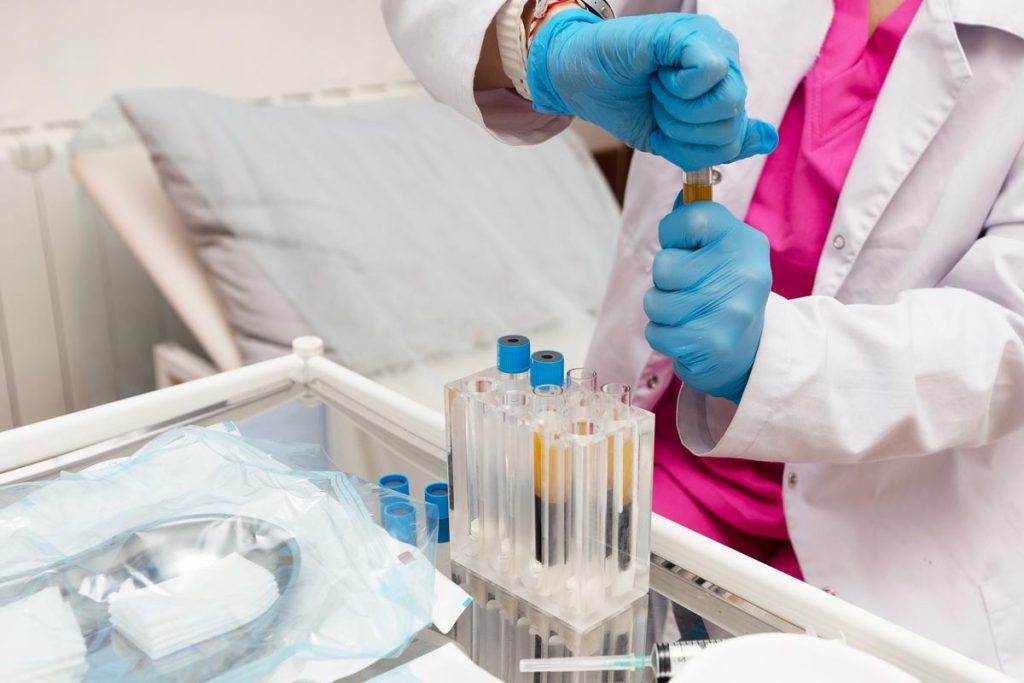 Medical professional preparing regenerative medicine treatment samples in a clinical laboratory setting