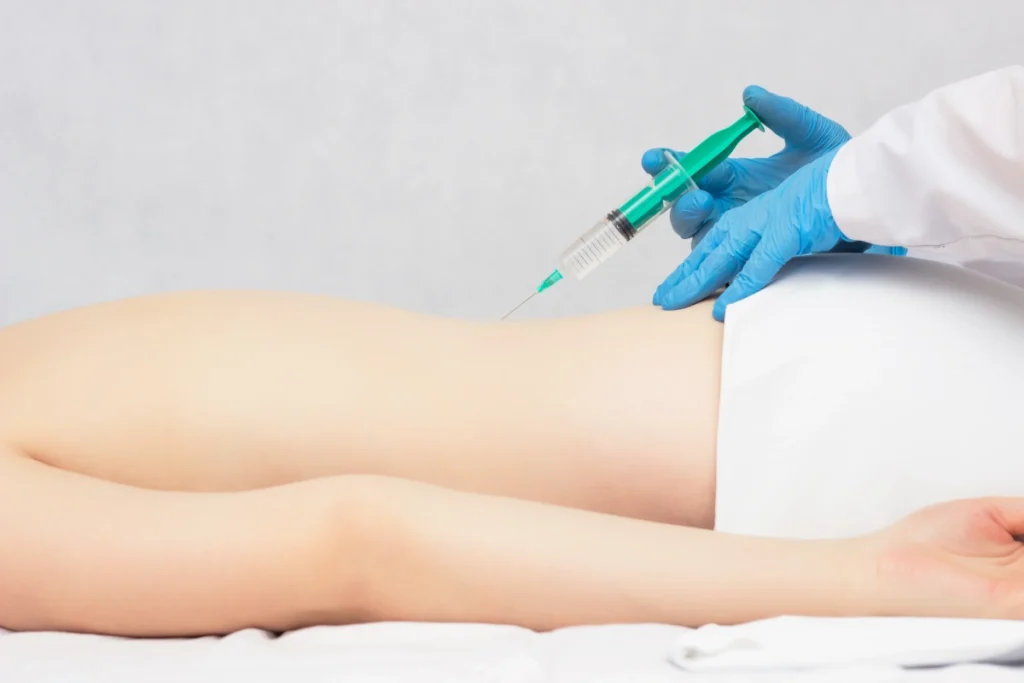 Doctor performing SI joint injection for lower back pain diagnosis.