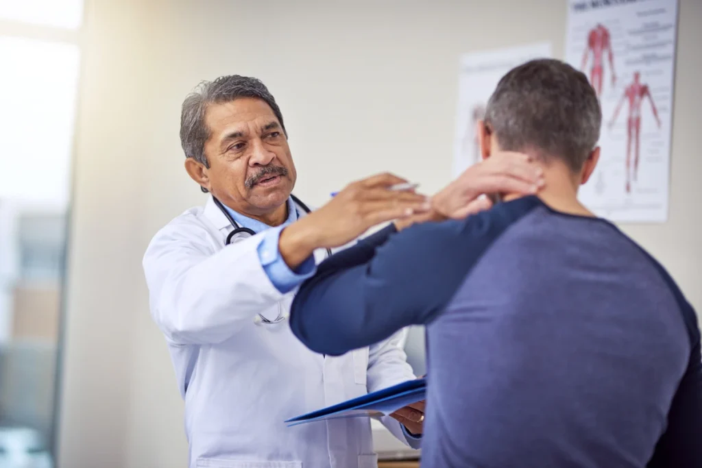 Physician examining a patient with neck pain and headache symptoms while evaluating spinal health and treatment options for chronic neck discomfort.